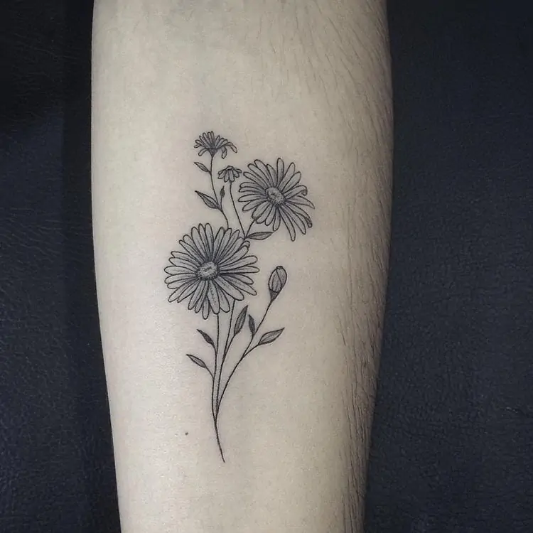 Minimalist flower tattoo on the inner arm