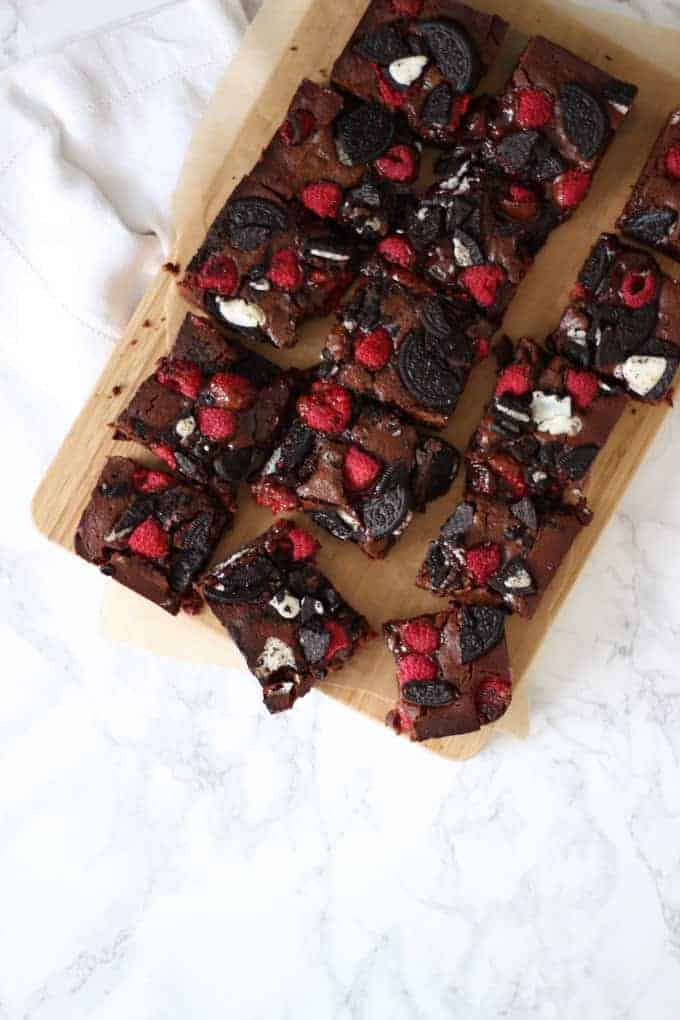 Oreo brownies with raspberries in a sheet.