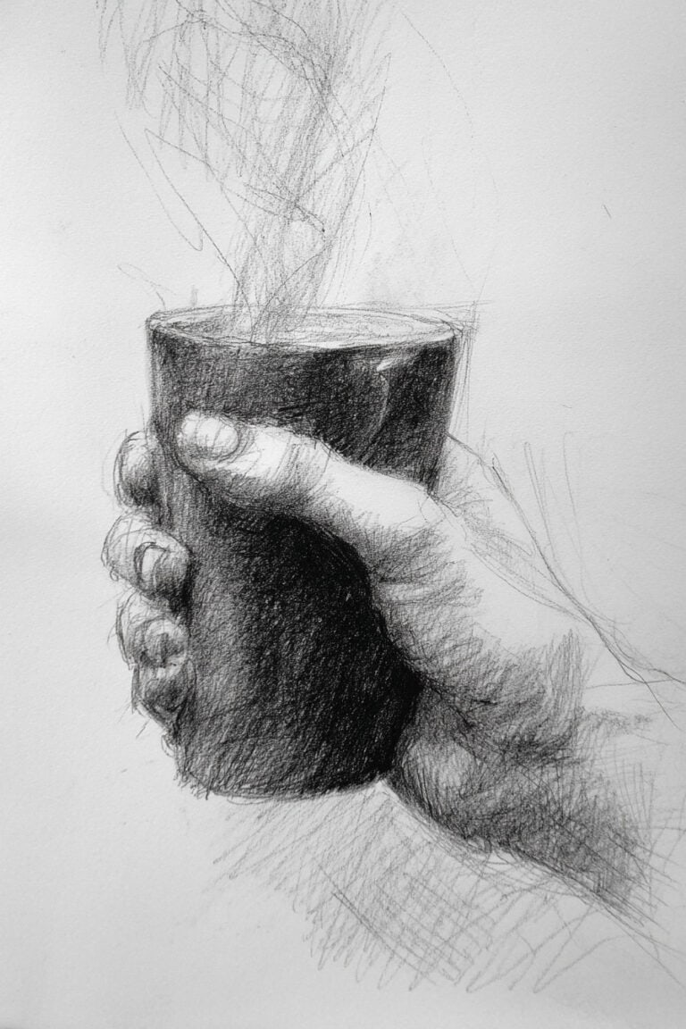 A hand holding a cup