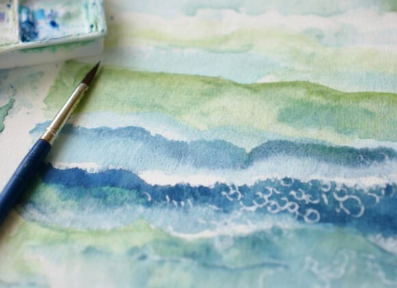 emthehuman1_a_watercolor_brush_next_to_a_painting_of_a_loose_wa_6284f253-b9a9-4aa8-9edd-ae163ef0d114