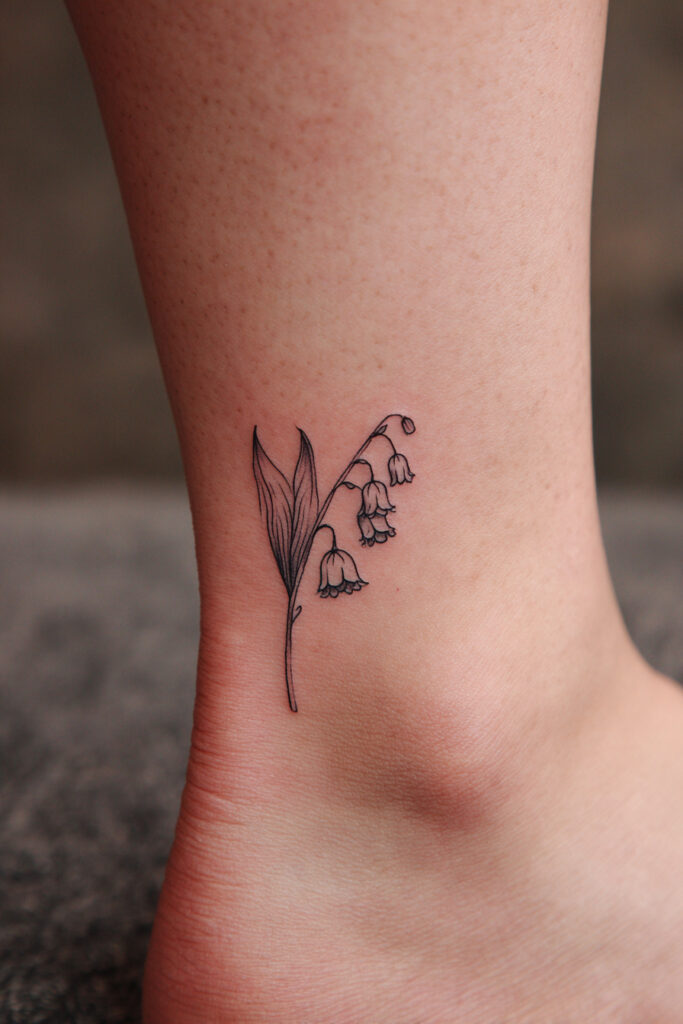 Lily of the valley minimalist tattoo with detailed thin lines.