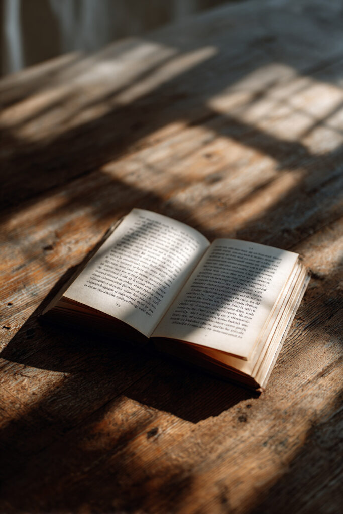 Open book with natural window light aesthetic photography.