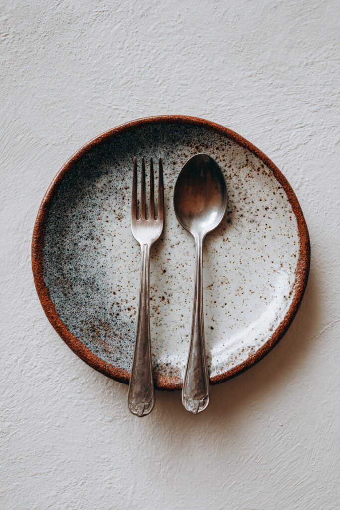 Minimal plate and cutlery photography composition study.